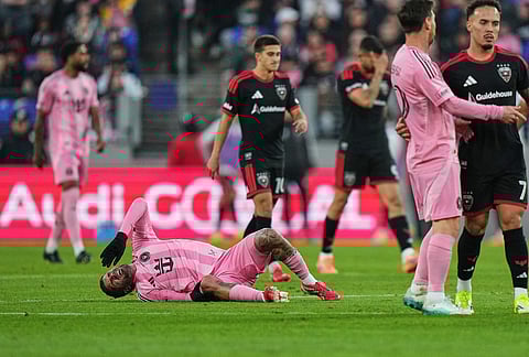 Inter Miami midfielder Rodrigo de Paul, left, reacts after being fouled against by D.C. United forward João Peglow (7) during the second half of an MLS soccer match, in Baltimore.