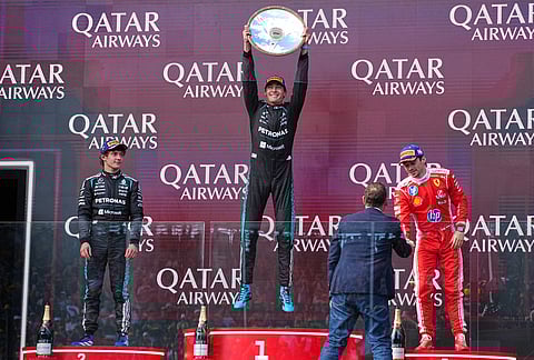 Mercedes driver George Russell, centre, of Britain celebrates after winning the Australian Formula One Grand Prix with second placed teammate Andrea Kimi Antonelli, left, of Italy and third placed Ferrari driver Charles Leclerc, right, of Monaco at Albert Park, in Melbourne, Australia.