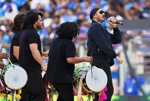 Indian singer Sukhbir Singh, right, performs during the closing ceremony of the T20 World Cup cricket final match between India and New Zealand in Ahmedabad.