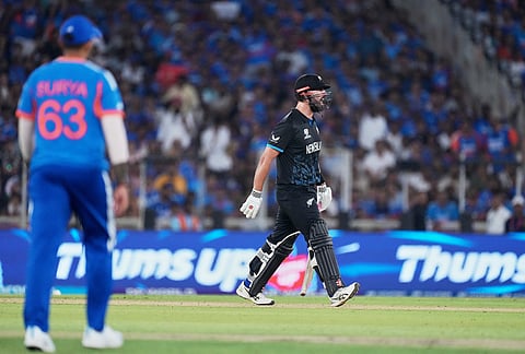 New Zealand's Daryl Mitchell walks toward India's Arshdeep Singh to have a word with him during the T20 World Cup cricket final match between India and New Zealand in Ahmedabad.