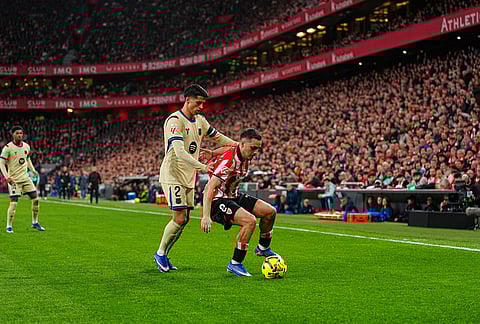 Athletic Bilbao's Andoni Gorosabel, right, protects the ball from Barcelona's Joao Cancelo during the Spanish La Liga soccer match between Athletic Bilbao and Barcelona in Bilbao, Spain.