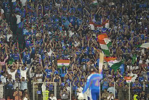 Crowd cheer as India's Abhishek Sharma celebrates his fifty runs during the T20 World Cup cricket final match between India and New Zealand in Ahmedabad.
