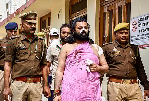 Ashutosh Brahmachari, who had filed a complaint alleging that Swami Avimukteshwaranand Saraswati sexually exploited students at his ashram, being taken for medical examination after he was attacked by an unidentified person with a razor on a train, in Prayagraj.