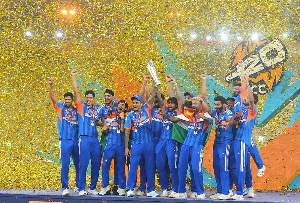 India's players celebrate with the trophy after winning the T20 World Cup final match against New Zealand, in Ahmedabad.
 - | Photo: AP/Rafiq Maqbool