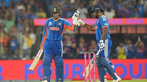 India's Abhishek Sharma celebrates his fifty runs with batting partner India's Sanju Samson during the T20 World Cup cricket final match between India and New Zealand in Ahmedabad, India, Sunday, March 8, 2026.