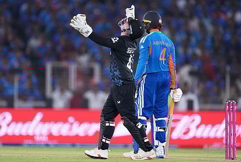 New Zealand's Tim Seifert, left, celebrates the wicket of India's Abhishek Sharma, right, during the T20 World Cup cricket final match between India and New Zealand in Ahmedabad.