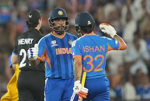 India's Sanju Samson, center, celebrates his fifty runs during the T20 World Cup cricket final match between India and New Zealand in Ahmedabad.