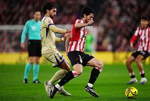 Athletic Bilbao's Daniel Vivian and Barcelona's Ferran Torres compete for the ball during the Spanish La Liga soccer match between Athletic Bilbao and Barcelona in Bilbao, Spain.
