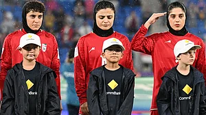 | Photo: AP/DAVE HUNT : Iran players react during their national anthem ahead of the Women's Asian Cup soccer match between Iran and the Philippines in Robina, Australia, Sunday, March 8, 2026.