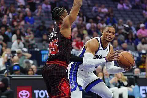 Sacramento Kings guard Russell Westbrook, right, is fouled by Chicago Bulls forward Isaac Okoro (35) during the first half of an NBA basketball game in Sacramento, Calif.