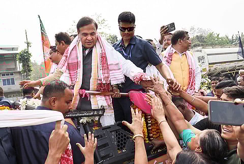 Assam Chief Minister Himanta Biswa Sarma greets supporters during the BJP's Jana Ashirwad Yatra ahead of the 2026 Assembly elections at Pathshala, in Bajali district of Assam.