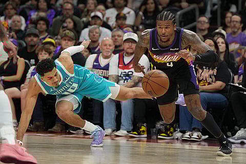 Phoenix Suns guard Jalen Green (4) drives past Charlotte Hornets guard Josh Green during the first half of an NBA basketball game in Phoenix.