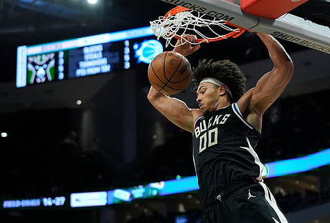 Milwaukee Bucks' Jericho Sims dunks during the first half of an NBA basketball game against the Orlando Magic, in Milwaukee.