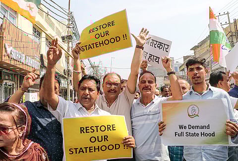 Congress workers stage a protest against the USA trade deal and demand restoration of statehood for Jammu and Kashmir outside the party office, in Jammu.