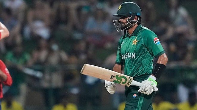 Pakistan's Babar Azam leaves the ground after losing his wicket as England's Jamie Overton, left, celebrates with teammates during the T20 World Cup cricket match between England and Pakistan in Pallekele, Sri Lanka. - | Photo: AP/Eranga Jayawardena