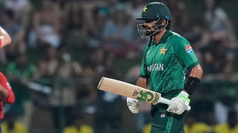 Pakistan's Babar Azam leaves the ground after losing his wicket as England's Jamie Overton, left, celebrates with teammates during the T20 World Cup cricket match between England and Pakistan in Pallekele, Sri Lanka. - | Photo: AP/Eranga Jayawardena