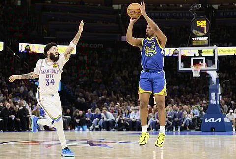 Golden State Warriors guard LJ Cryer (18) shoots over Oklahoma City Thunder guard Kenrich Williams (34) during the second half of an NBA basketball game in Oklahoma City.