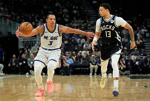 Orlando Magic's Desmond Bane (3) drives to the basket against Milwaukee Bucks' Ryan Rollins during the second half of an NBA basketball game in Milwaukee.
