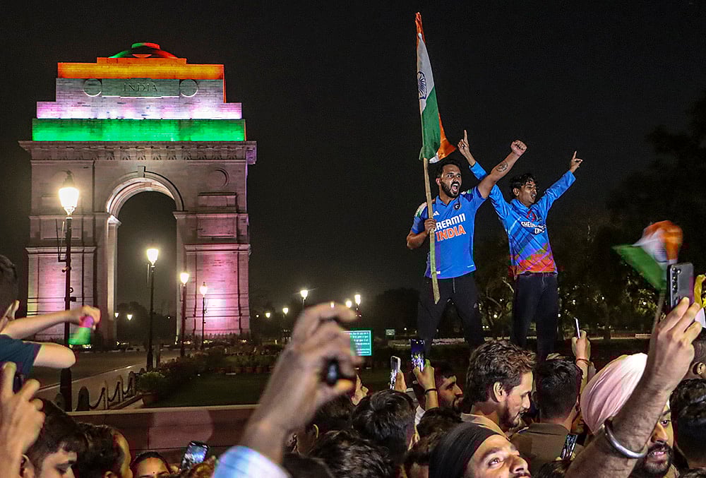 Cricket fans celebrate after India defeated New Zealand to win the ICC Men's T20 World Cup 2026 final near India Gate, in New Delhi. - | Photo: PTI