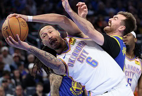 Oklahoma City Thunder forward Jaylin Williams (6) secures the ball against Golden State Warriors guard Pat Spencer, right, during the second half of an NBA basketball game in Oklahoma City.