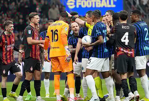 Players argue during the Serie A soccer match between AC Milan and Inter Milan, in Milan, Italy.