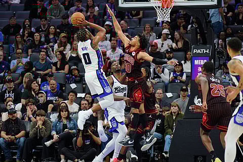 Sacramento Kings guard Malik Monk (0) shoots the ball against Chicago Bulls guard Tre Jones (30) during the second half of an NBA basketball game in Sacramento, Calif.