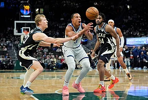 | Photo: AP/Aaron Gash : Orlando Magic's Desmond Bane (3) loses control of the ball between Milwaukee Bucks' AJ Green and Cam Thomas during the second half of an NBA basketball game in Milwaukee.