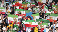 Three Iran Women’s Football Team Members Depart Australia, Return Home Amid Refugee Visa Drama | Photo: AP/DAVE HUNT : Iran supporters wave flags during the Women's Asian Cup soccer match between Iran and the Philippines in Robina, Australia, Sunday, March 8, 2026.