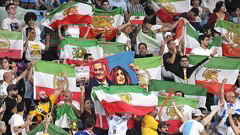 Iran supporters wave flags during the Women's Asian Cup soccer match between Iran and the Philippines in Robina, Australia, Sunday, March 8, 2026.
