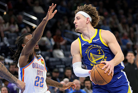 Golden State Warriors guard Brandin Podziemski (2) looks to pass the ball away from Oklahoma City Thunder guard Cason Wallace (22) during the second half of an NBA basketball game in Oklahoma City.
