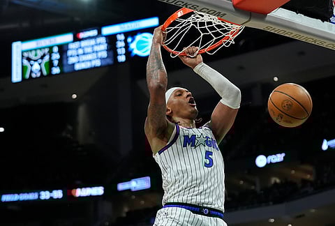 Orlando Magic's Paolo Banchero dunks during the second half of an NBA basketball game against the Milwaukee Bucks, in Milwaukee.