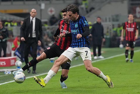 AC Milan's Christian Pulisic, left, and Inter Milan's Piotr Zielinski fight for the ball during the Serie A soccer match between AC Milan and Inter Milan, in Milan, Italy.