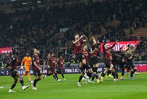 AC Milan players celebrate after the Serie A soccer match between AC Milan and Inter Milan, in Milan, Italy.