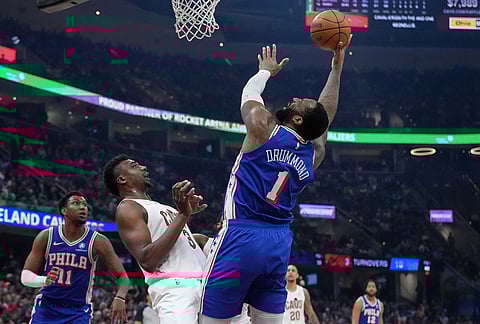 Philadelphia 76ers center Andre Drummond (1) goes up for a shot in front of Cleveland Cavaliers center Thomas Bryant (3) in the second half of an NBA basketball game in Cleveland.