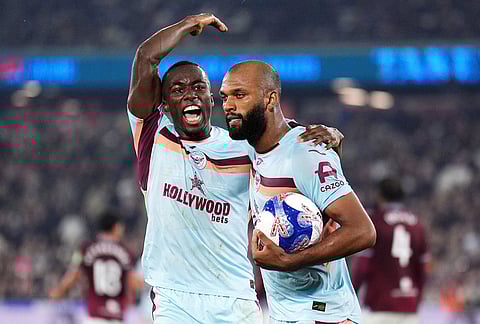 Brentford's Igor Thiago, right, celebrates scoring with Michael Kayode  during the English FA Cup fifth round soccer match between West Ham United and Brentford in London.
