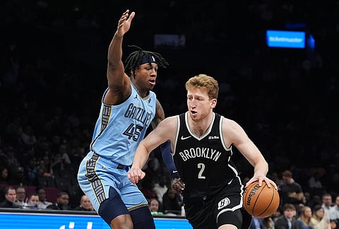 Brooklyn Nets' Danny Wolf (2) drives past Memphis Grizzlies' GG Jackson (45) during the first half of an NBA basketball game in New York.
