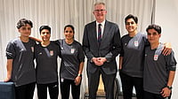 Australia Ministry of Home Affairs via AP : In this photo supplied by Australia's Minister for Home Affairs Tony Burke's office, the Minister Tony Burke, center, poses in an undisclosed location with five Iranian women soccer players who have been granted asylum in Australia.