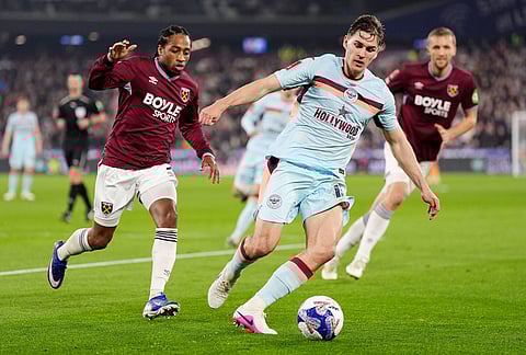 Brentford's Yehor Yarmolyuk and West Ham United's Kyle Walker-Peters, left, in action during the English FA Cup fifth round soccer match between West Ham United and Brentford in London.