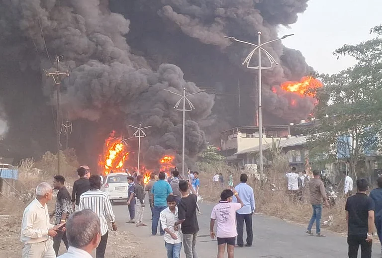 People gather as flames and smoke billow after a massive fire broke out at Shree Ganesh Chemicals Company, in Ambernath, Thane. - | Photo: PTI