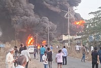 Day In Pics: March 10, 2026 | Photo: PTI : People gather as flames and smoke billow after a massive fire broke out at Shree Ganesh Chemicals Company, in Ambernath, Thane.