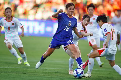 Japan's Momoko Tanikawa and Vietnam's Trần Thị Thu Thảo, right, compete for the ball during the Women's Asian Cup soccer match between Japan and Vietnam in Perth, Australia.
