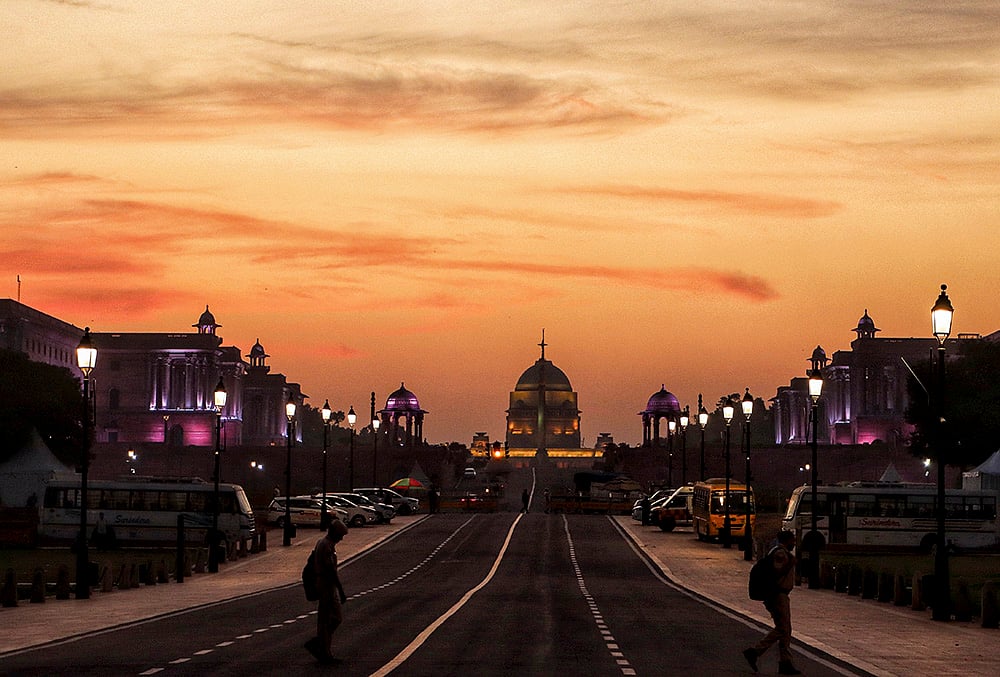 Rashtrapati Bhavan glows at sunset under orange clouds in Delhi