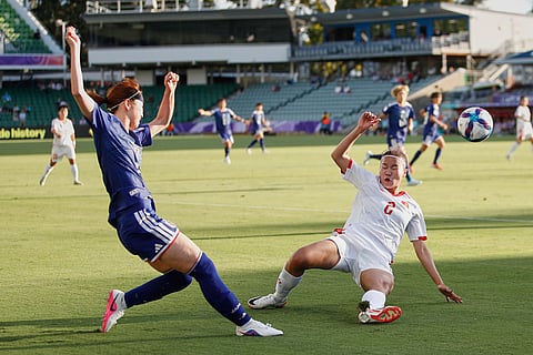 Japan's Riko Ueki, left, kicks the ball past Vietnam's Lương Thị Thu Thương during the Women's Asian Cup soccer match between Japan and Vietnam in Perth, Australia.