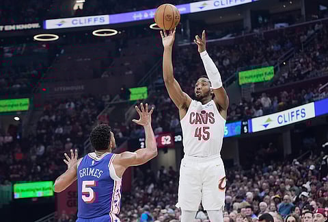 Cleveland Cavaliers guard Donovan Mitchell (45) shoots over Philadelphia 76ers guard Quentin Grimes (5) in the first half of an NBA basketball game in Cleveland.