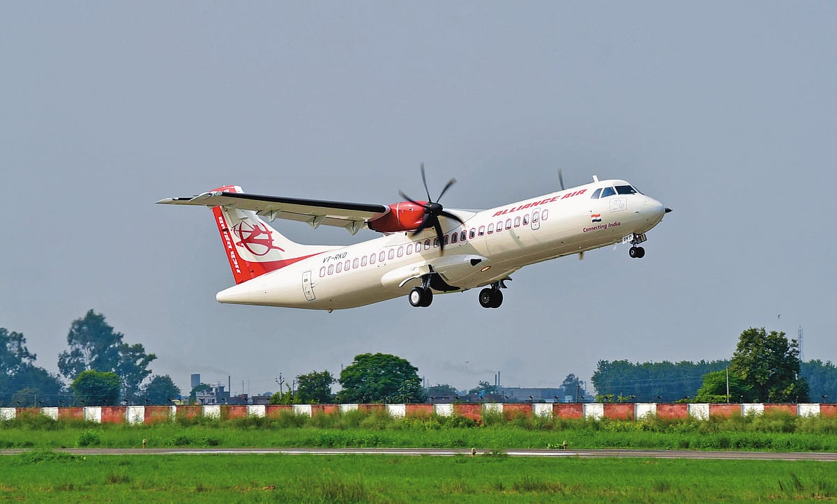 Alliance Air regional aircraft departs the airport, climbing above a grassy runway in Uttar Pradesh - null