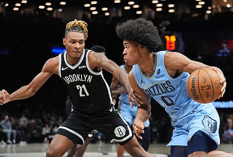 Memphis Grizzlies' Jaylen Wells (0) drives past Brooklyn Nets' Noah Clowney (21) during the second half of an NBA basketball game in New York.