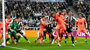 | Photo: AP/Owen Humphreys : Barcelona's Raphael Raphinha, center, clears the ball during the Champions League round of 16 first leg soccer match between Newcastle United and Barcelona in Newcastle, England, Tuesday, March 10, 2026.