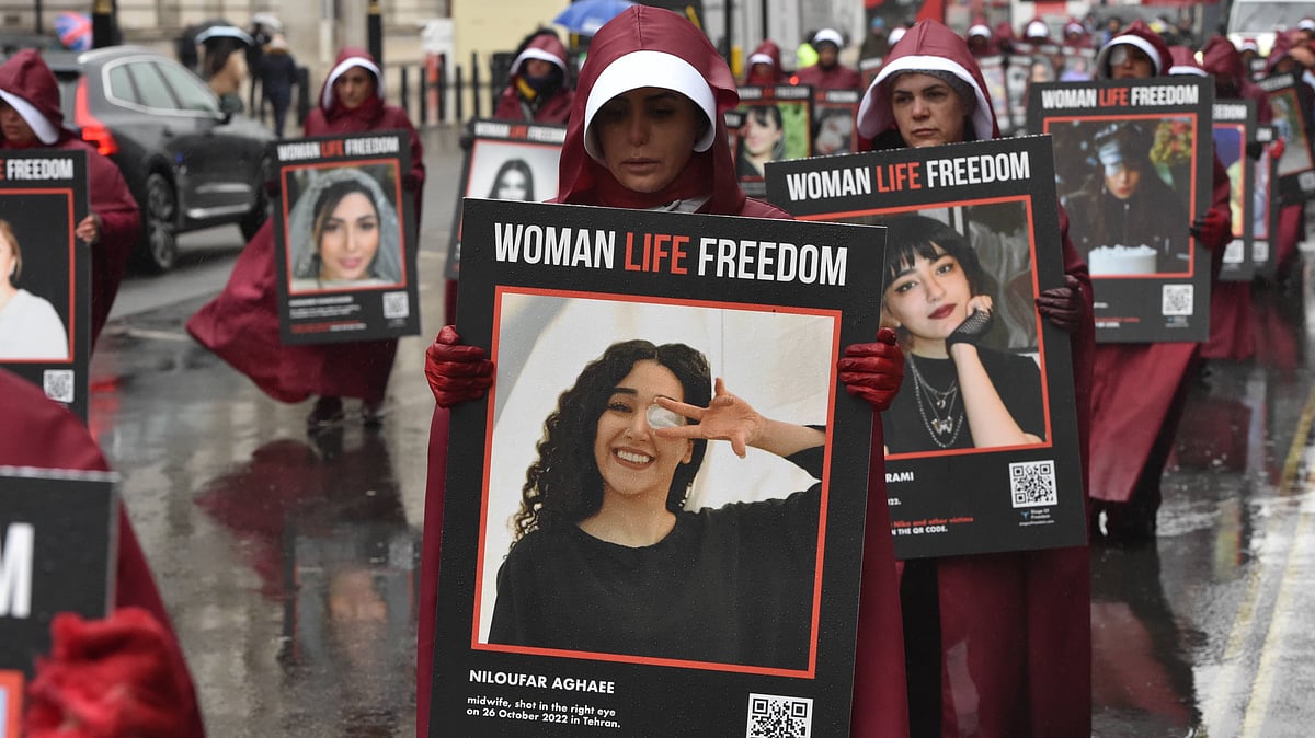 Protesters dressed up as handmaids marched through Whitehall holding placards with pictures of the victims of the growing freedom uprising in Iran, over the death of Mahsa Amini following her arrest by Iranian morality police. -  IMAGO / ZUMA Press Wire