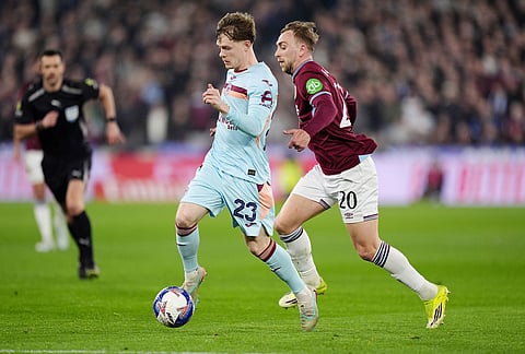 Brentford's Keane Lewis-Potter, left, and West Ham United's Jarrod Bowen in action during the English FA Cup fifth round soccer match between West Ham United and Brentford in London.