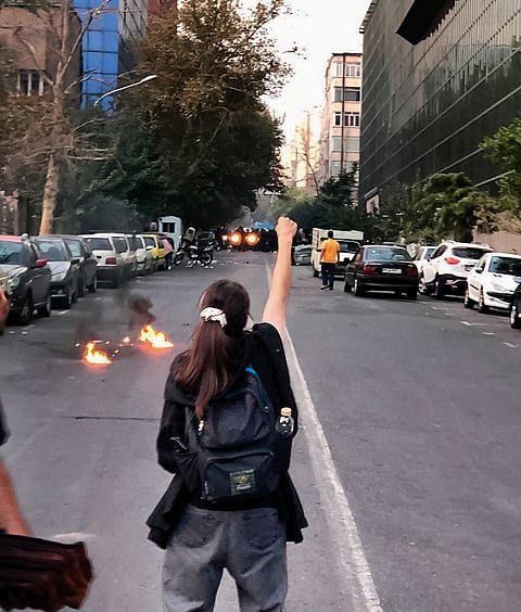 Women, Life, Freedom: In 2022, 22-year-old Kurdish-Iranian Mahsa Jina Amini died in a hospital in Tehran. The Guidance Patrol, the religious morality police of Iran’s government, had arrested Amini for allegedly not wearing the hijab in accordance with government standards. Alleged police brutality led to her death. Amini’s death resulted in a series of protests. During the ensuing events, some female demonstrators removed their hijab or publicly cut their hair as acts of protest